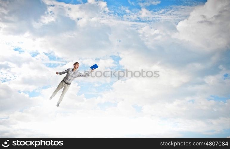 Books let you rise above the rest. Young handsome man in casual reaching hand with book