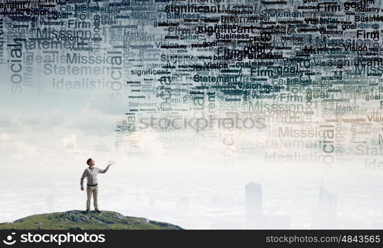 Books let you rise above the rest. Young handsome man in casual reaching hand with book