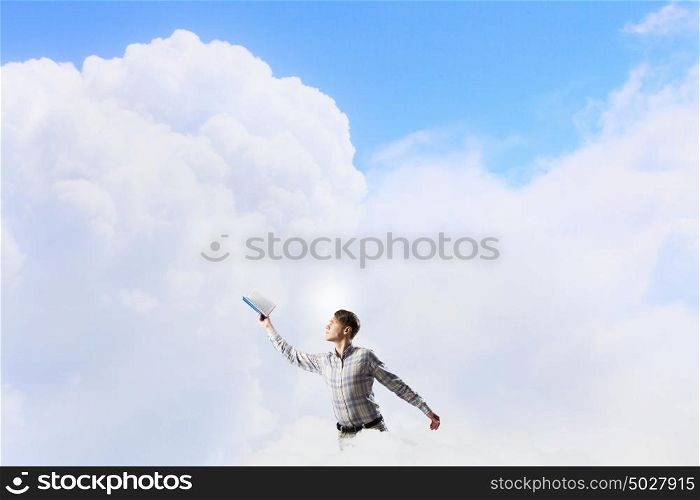 Books let you rise above the rest. Young handsome man in casual reaching hand with book
