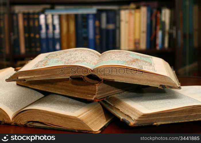 books on table in dark library room