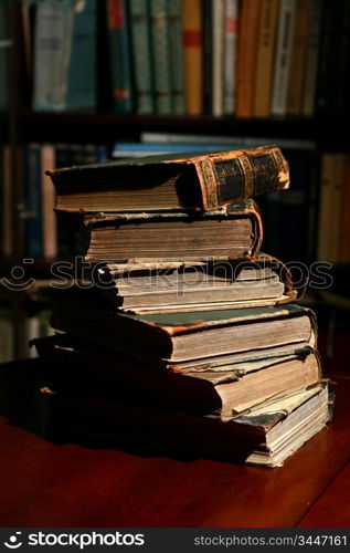 books on table in dark library room