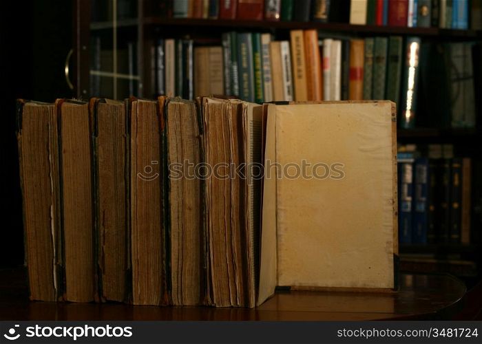 books on table in dark library room
