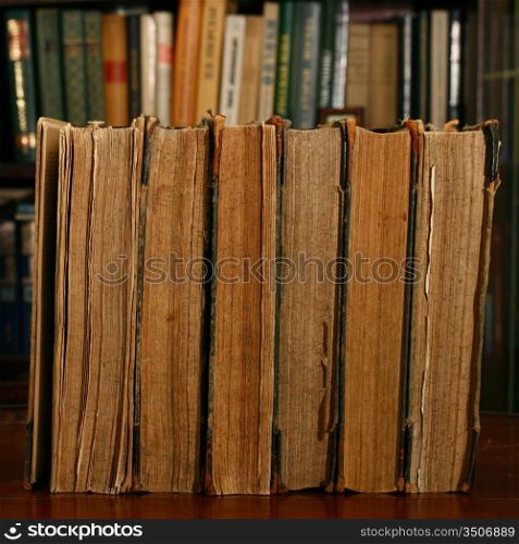 books on table in dark library room