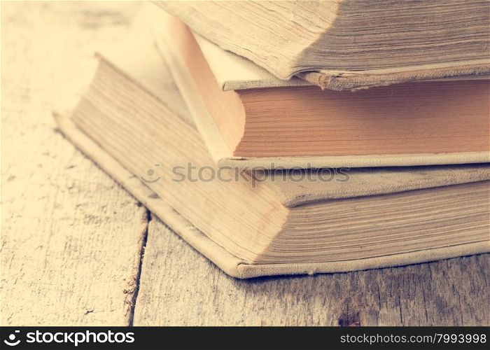 Books on wooden background in vintage tone color