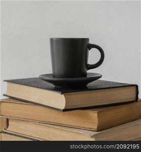 books stack indoors coffee cup