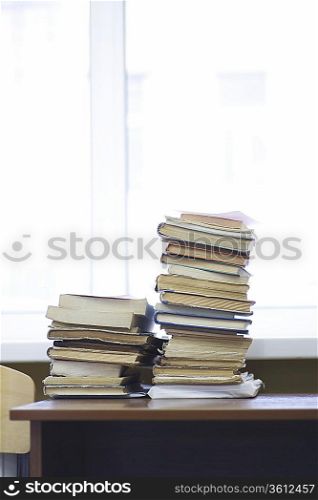 Books stacked on library table