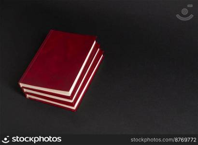 books with red cover on black background, isolated. back to school. book on black background