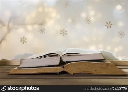 books wood table near bank snow snowflakes fairy lights