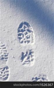 Boot footprint pattern in pure white winter snow