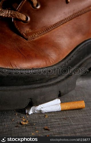 Boot treading cigarette tobacco addiction concept metaphor