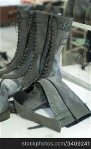 Boots arranged on shelves in footwear factory
