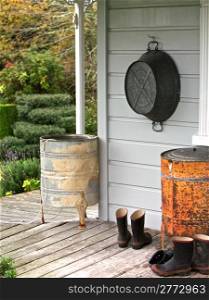 Boots at Entrance to Porch Welcome Home. Farm house, back porch