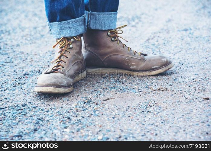 Boots safety worker at construction site. Engineer Wear Jeans And Brown Boots for Worker Security on Background of Refinery. Engineer safety industry fashion foot walking outdoor.