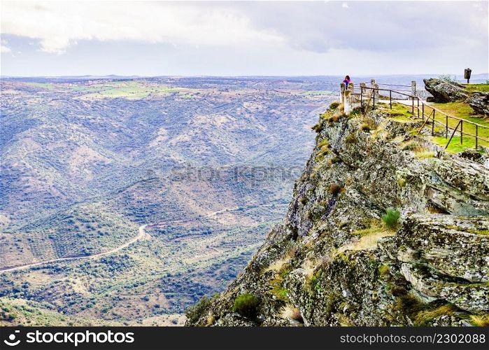 Border between Portugal and Spain. Tourist woman at Penedo Durao lookout. Mountain landscape. National Parks.. Tourist woman in mountain nature