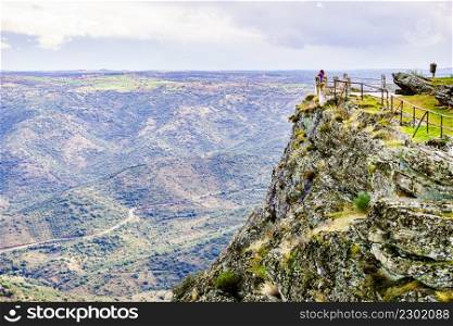 Border between Portugal and Spain. Tourist woman at Penedo Durao lookout. Mountain landscape. National Parks.. Tourist woman in mountain nature