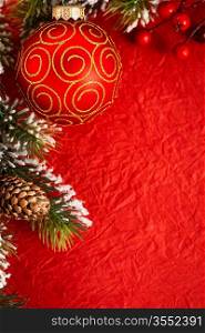 Border from Christmas tree decorations on red paper