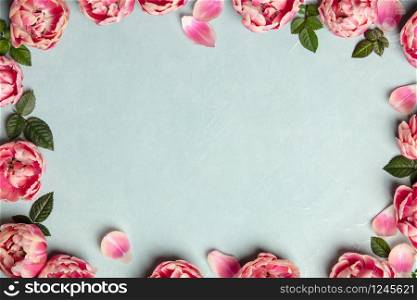 Border of beautiful pink tulips on blue shabby chic background, frame, top view, floral border