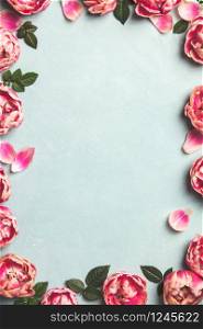 Border of beautiful pink tulips on blue shabby chic background, frame, top view, floral border