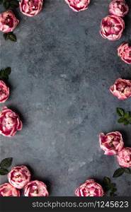 Border of beautiful pink tulips on dark shabby chic background, flat lay