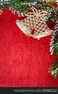Border of Christmas tree decoration and branch on red paper