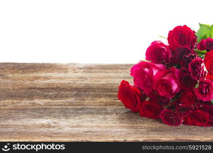 Border of red roses . red and pink roses on wooden table border isolated on white background