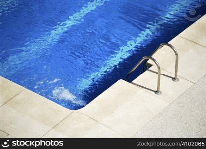 Border of the pool with metallic stairs