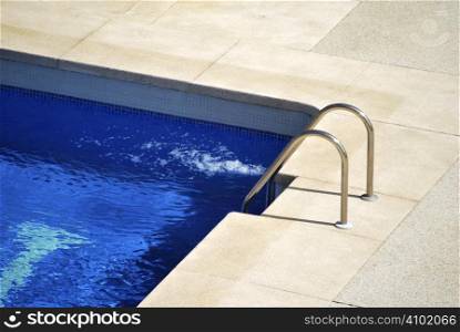 Border of the pool with metallic stairs