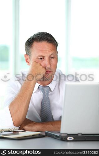 Bored businessman in front of computer