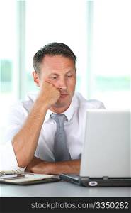 Bored businessman in front of computer