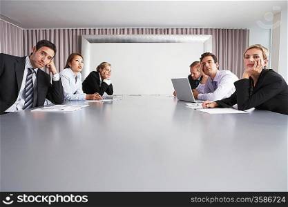 Bored Businesspeople Sitting in Conference Room