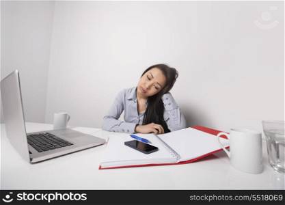 Bored businesswoman working at office desk