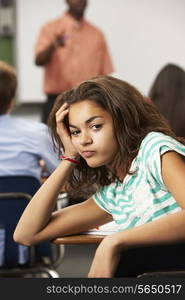 Bored Female Teenage Pupil In Classroom