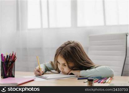 bored little girl taking notes