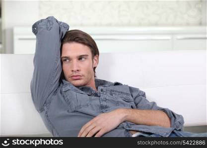 bored man in white sofa