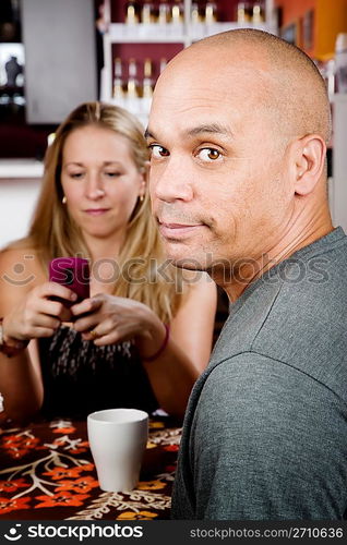 Bored man with woman on cell phone