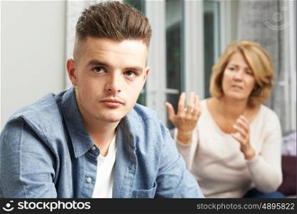 Bored Teenage Boy Being Told Off By Mother