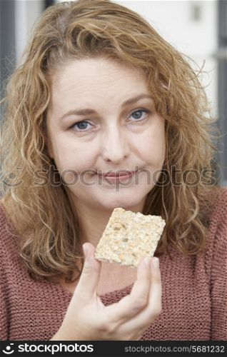 Bored Woman On Diet Eating Crispbread At Home