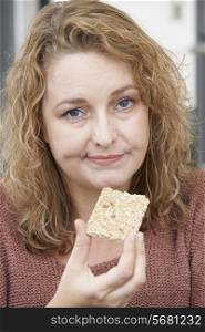Bored Woman On Diet Eating Crispbread At Home