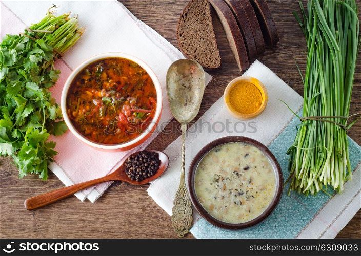 Borsch and mushroom soup served on table. The borsch and mushroom soup served on table