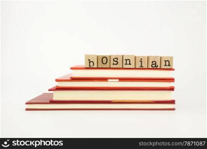 bosnian word on wood stamps stack on books, language and academic concept