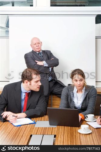 Boss and businessman looking down in contempt on a secretary for messing up