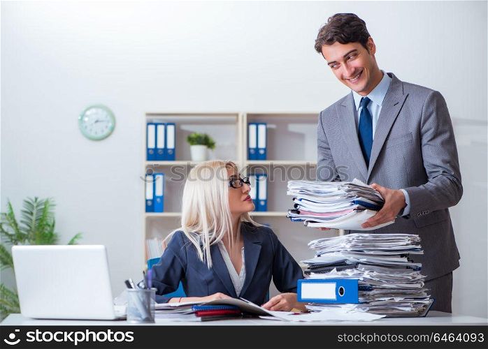 Boss bringing additional work to his assistant secretary