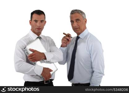 Boss holding cigar whilst employee does all the work
