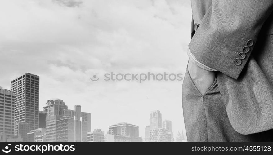 Bossy businessman. Close up of businessman standing on top viewing at city