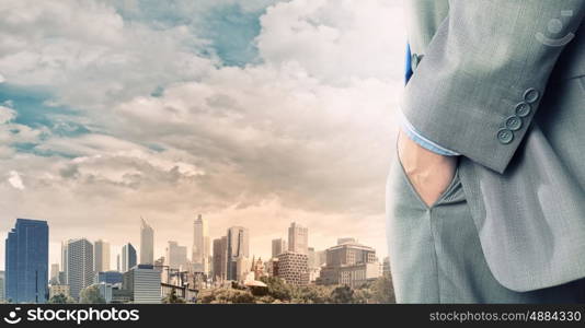 Bossy businessman. Close up of businessman standing on top viewing at city