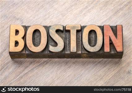 Boston word abstract in vintage letterpress wood type against grained wooden background