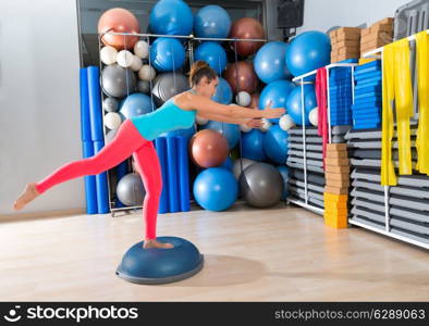 bosu one leg extension deadlift girl exercise at gym workout and swiss ball background