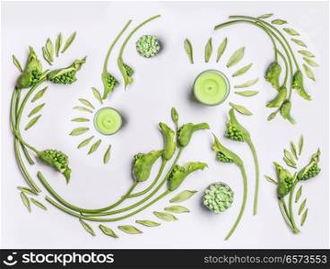 Botanical flat lay with leaves , green flowers and candles on white background, top view. Spa, wellness, beauty, relaxing and vegan skin care concept