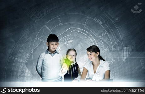 Botany lesson. Young teacher and school children at botany lesson