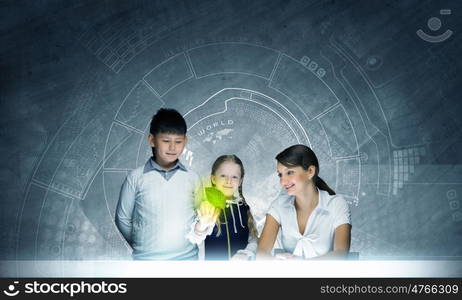 Botany lesson. Young teacher and school children at botany lesson